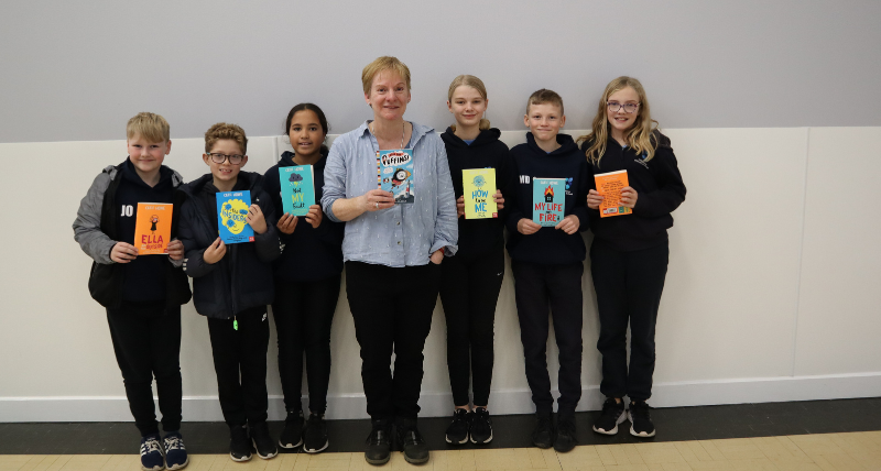 Author Cath Howe with year 6 children from Holystone Primary School at Killingworth Library