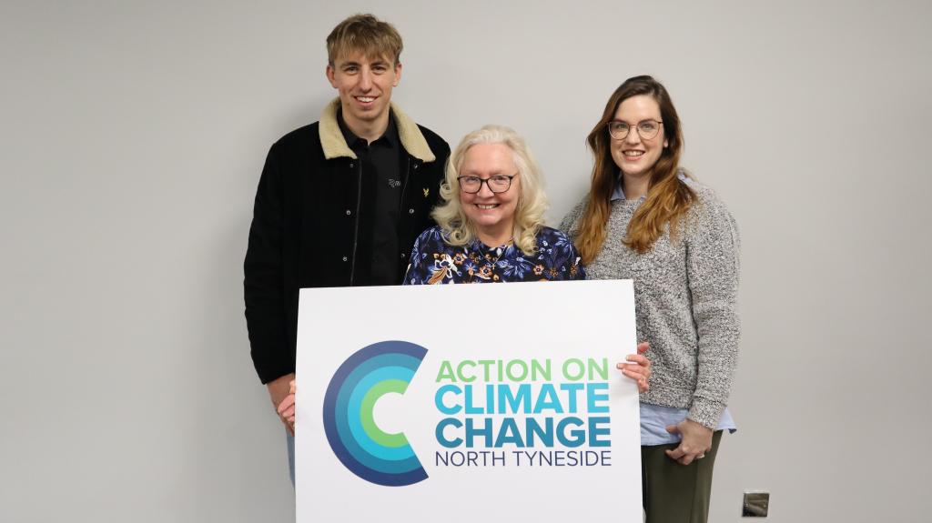 Officers from Quorum Park with Cllr Sandra Graham holding Action against Climate Change banner