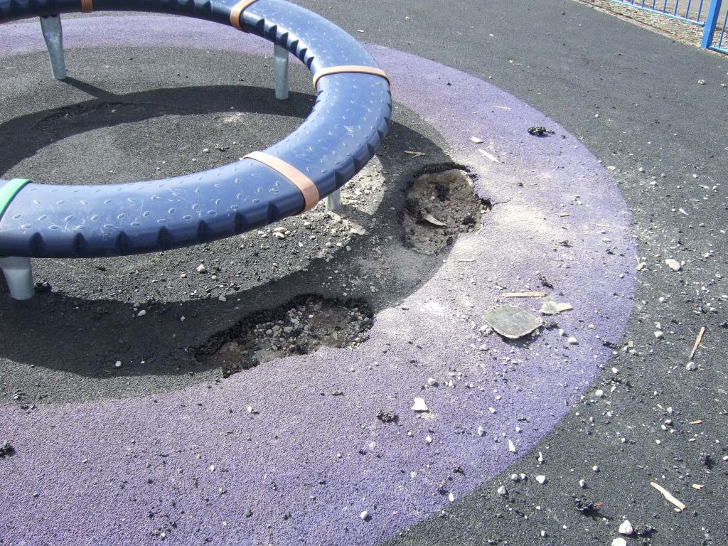 Damaged flooring under children's roundabout