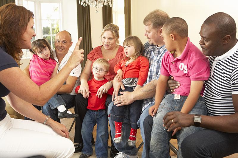 Support worker with families in a group session