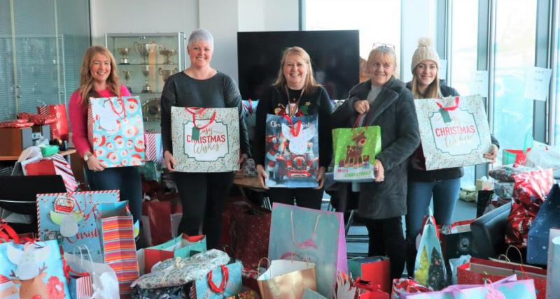 Council employees with staff from the Keel Row pub holding donated presents.