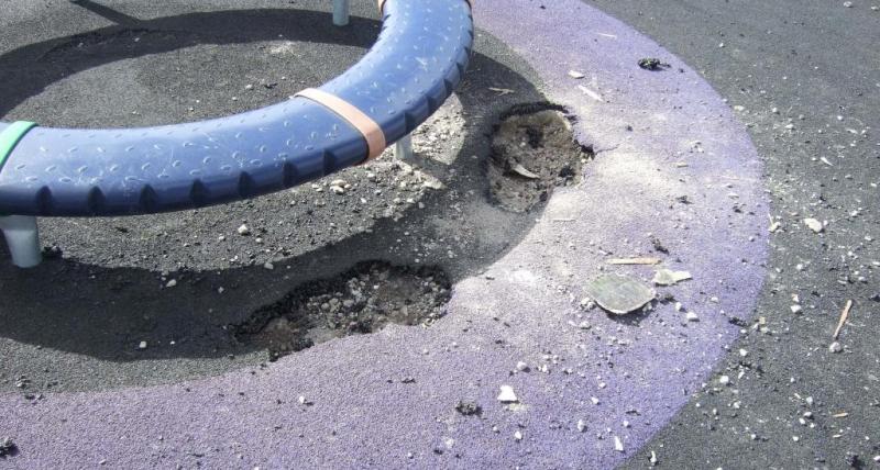 Damaged flooring under children's roundabout